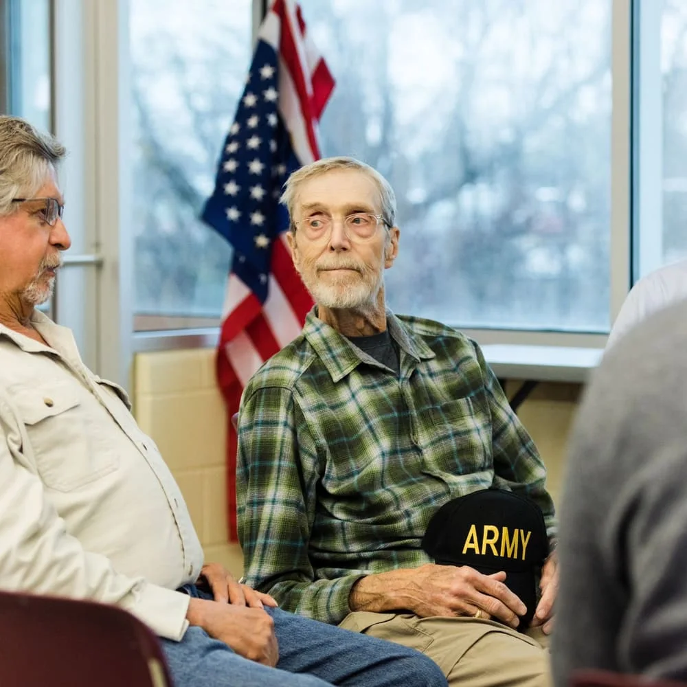 Older veteran relaxing comfortably in a seated group