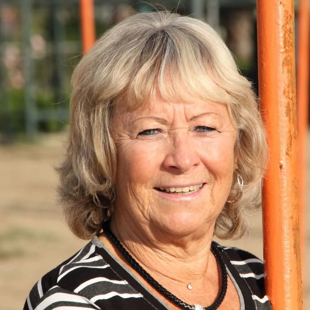 Smiling older woman standing comfortably outdoors